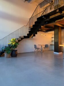 Polished concrete leading to spiral staircase